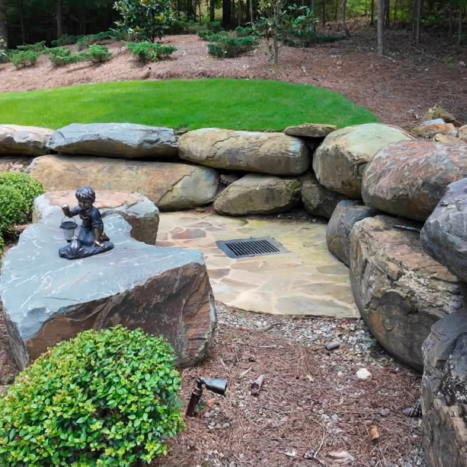 Boulder-lined drainage inlet integrated into a DSLD landscape